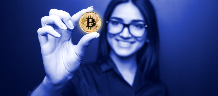 Woman holds bitcoin in hand