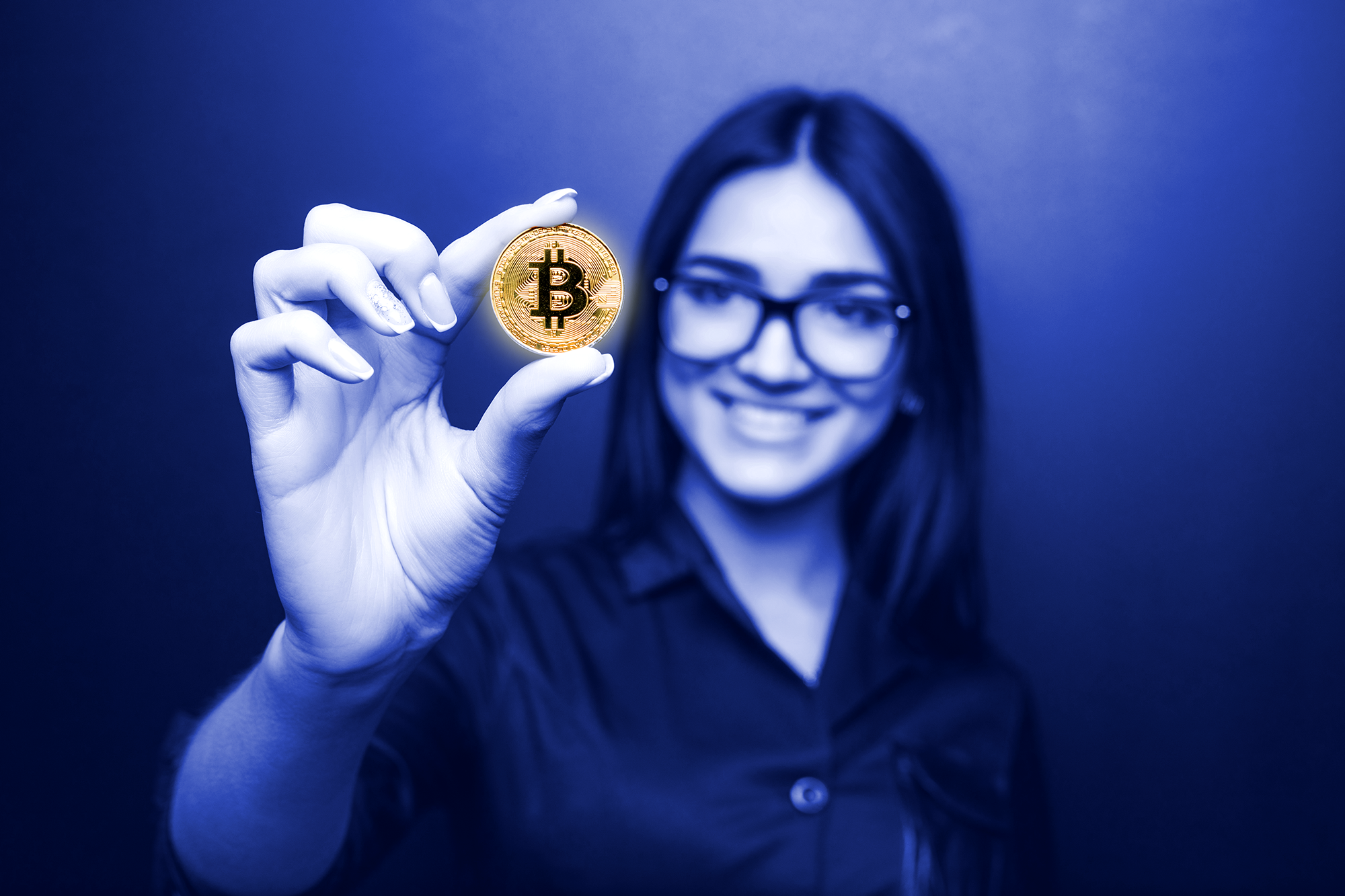 Woman holds bitcoin in hand